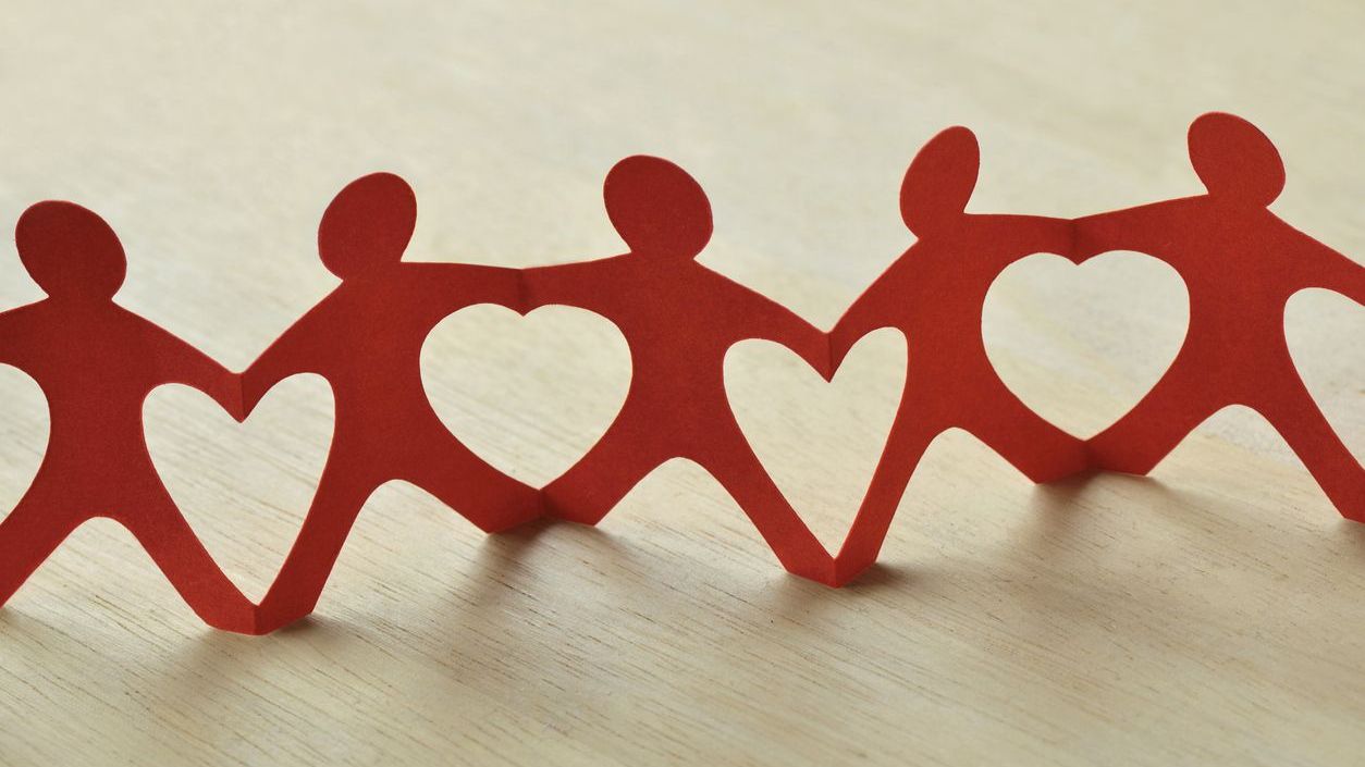 red paper chain of people with heart symbols