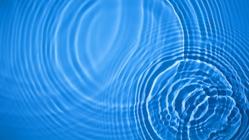 Circular ripples on clear blue water