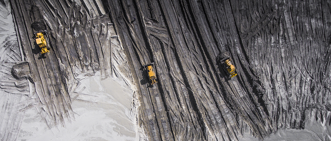 mining vehicles in a dark-grey setting