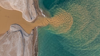 A river flowing into the ocean