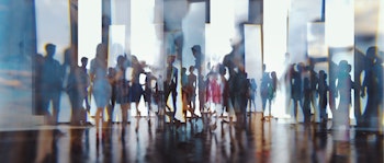 Long exposure of people walking across an open space office all blurred together