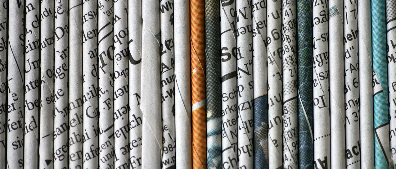rolled newspaper pages