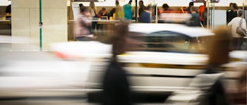 A blur of people and traffic moving in front of an office space