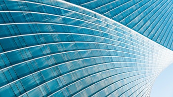 Close-up view of modern office building exterior with glass windows 